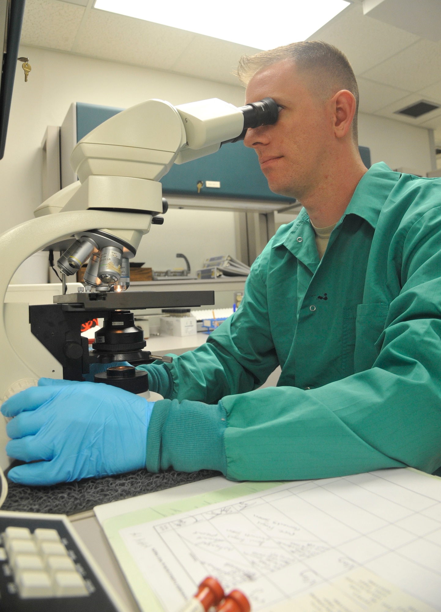 U.S. Air Force Staff Sgt. Jon Ringenoldus, 509th Medical Support Squadron medical laboratory technician, examines a KOH/ Wet prep sample at Whiteman Air Force Base, Mo., May 13, 2014. This sample is examined to determine if bacteria and yeast are present in the sample. (U.S. Air Force photo by Airman 1st Keenan Berry/Released)  