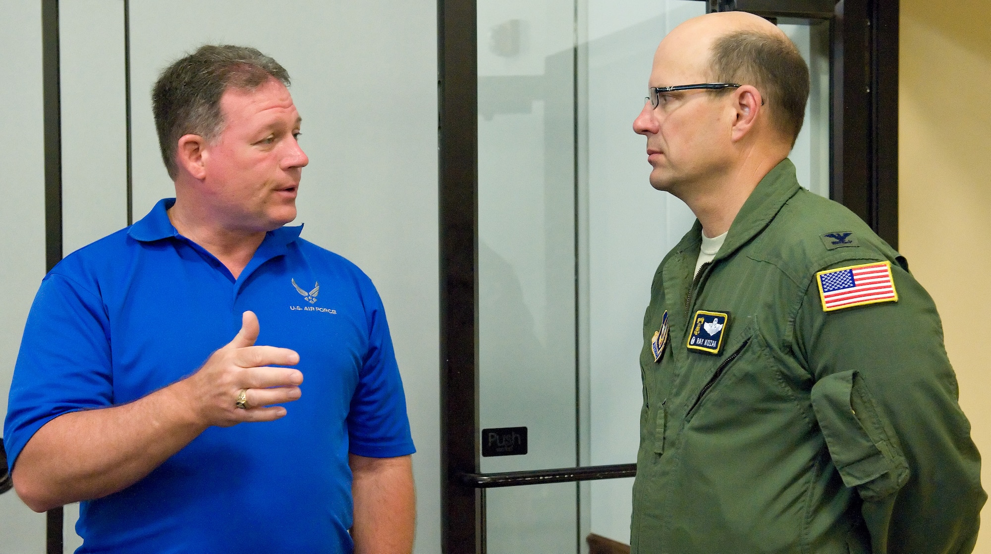 Herb Welday, intern, speaks with Col. Ray Kozak, 512th Airlift Wing commander, about becoming a photographer May 16, 2014, at Dover Air Force Base, Del. Welday is completing an internship program at Dover AFB to finish a bachelor’s degree at Wilmington University. (U.S. Air Force photo/Roland Balik)