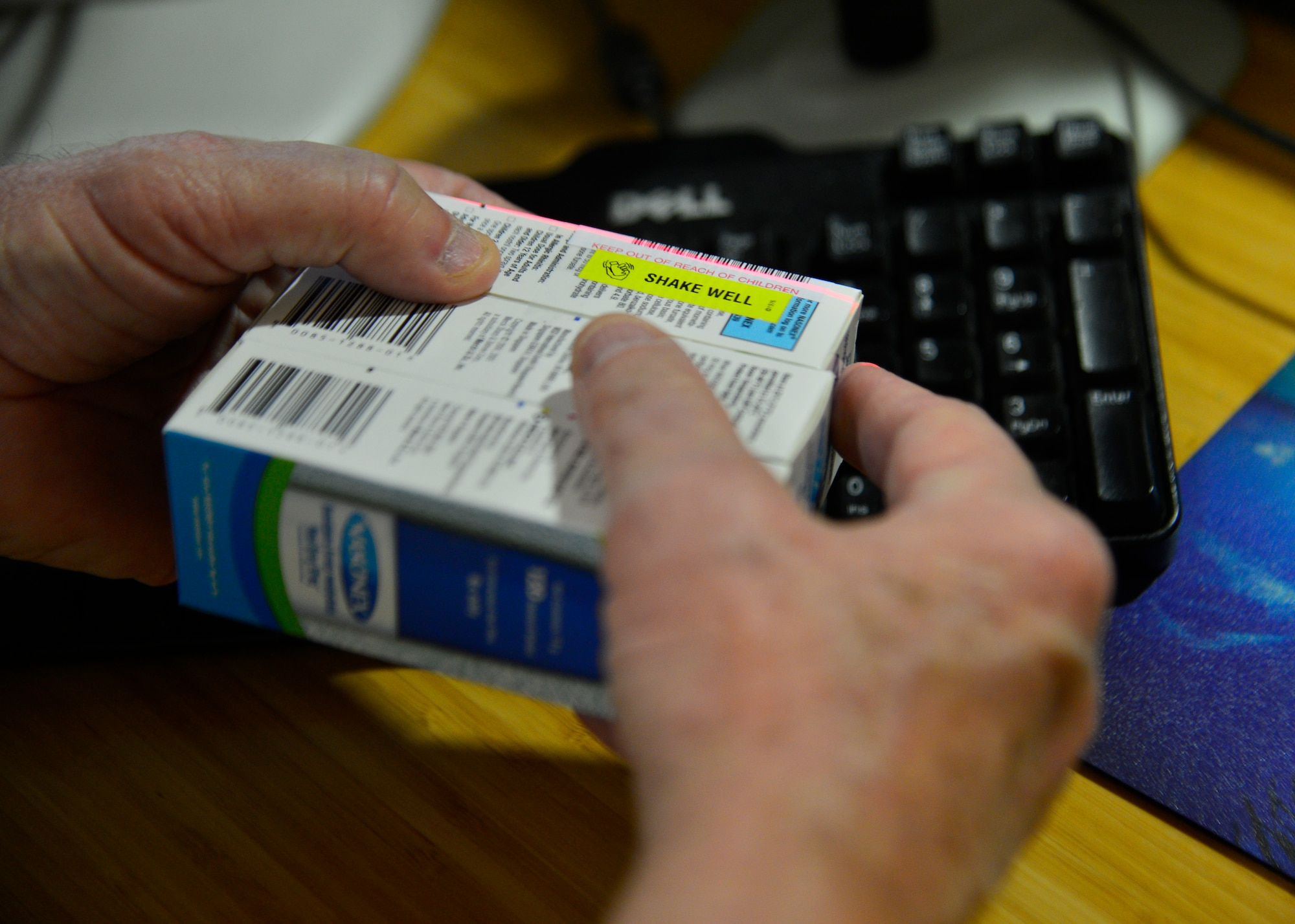 Joseph Saus, volunteer, scans a prescription medication into a database May 2, 2014, at the 436th Medical Group pharmacy on Dover Air Force Base, Del. Saus volunteers four hours a week in the pharmacy at the customer service window to distribute prescription medication. (U.S. Air Force photo/Airman 1st Class William Johnson)