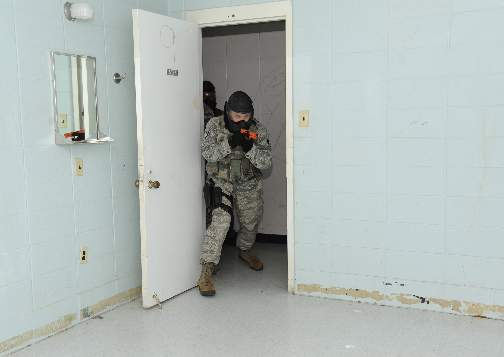 Staff Sgt. Joshua Remy, 186th Air Refueling Wing, Meridian Miss., prepares to enter a room in order to secure it during a scenario simulating real world conditions during an active shooter training session hosted by the Federal Bureau of Investigation May 21, 2014, at the Locker House, Keesler Air Force Base, Miss.  The two-day Advanced Law Enforcement Rapid Response Training focused on terrorism response tactics, which is designed to prepare the first responder to isolate, distract, and neutralize an "active shooter."  (U.S. Air Force photo by Kemberly Groue)
