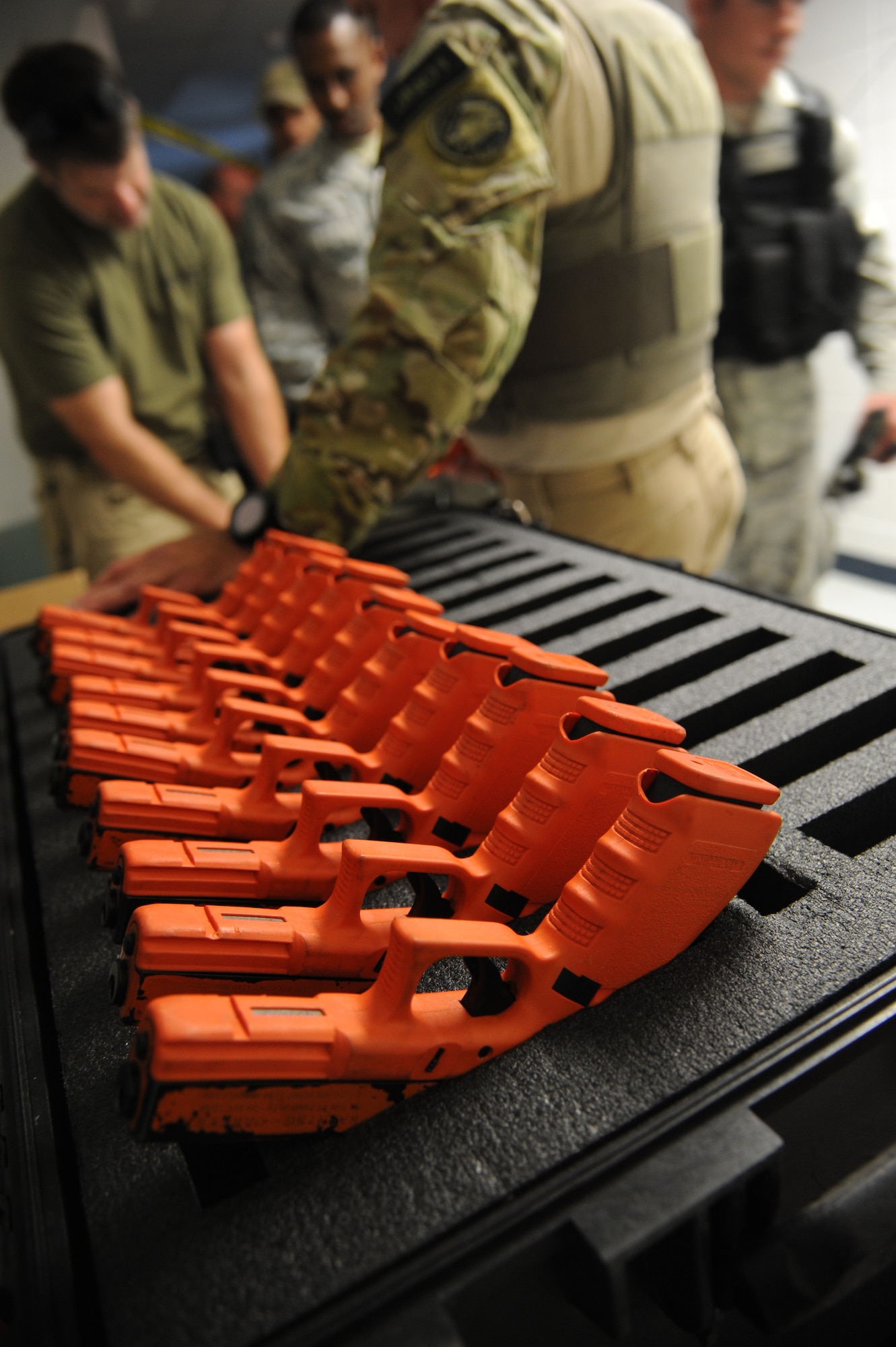 Training weapons sit on display while being assigned to trainees during an active shooter training session hosted by the Federal Bureau of Investigation May 21, 2014, at The Locker House, Keesler Air Force Base, Miss.  The two-day Advanced Law Enforcement Rapid Response Training focused on terrorism response tactics, which is designed to prepare the first responder to isolate, distract, and neutralize an "active shooter."  (U.S. Air Force photo by Kemberly Groue)