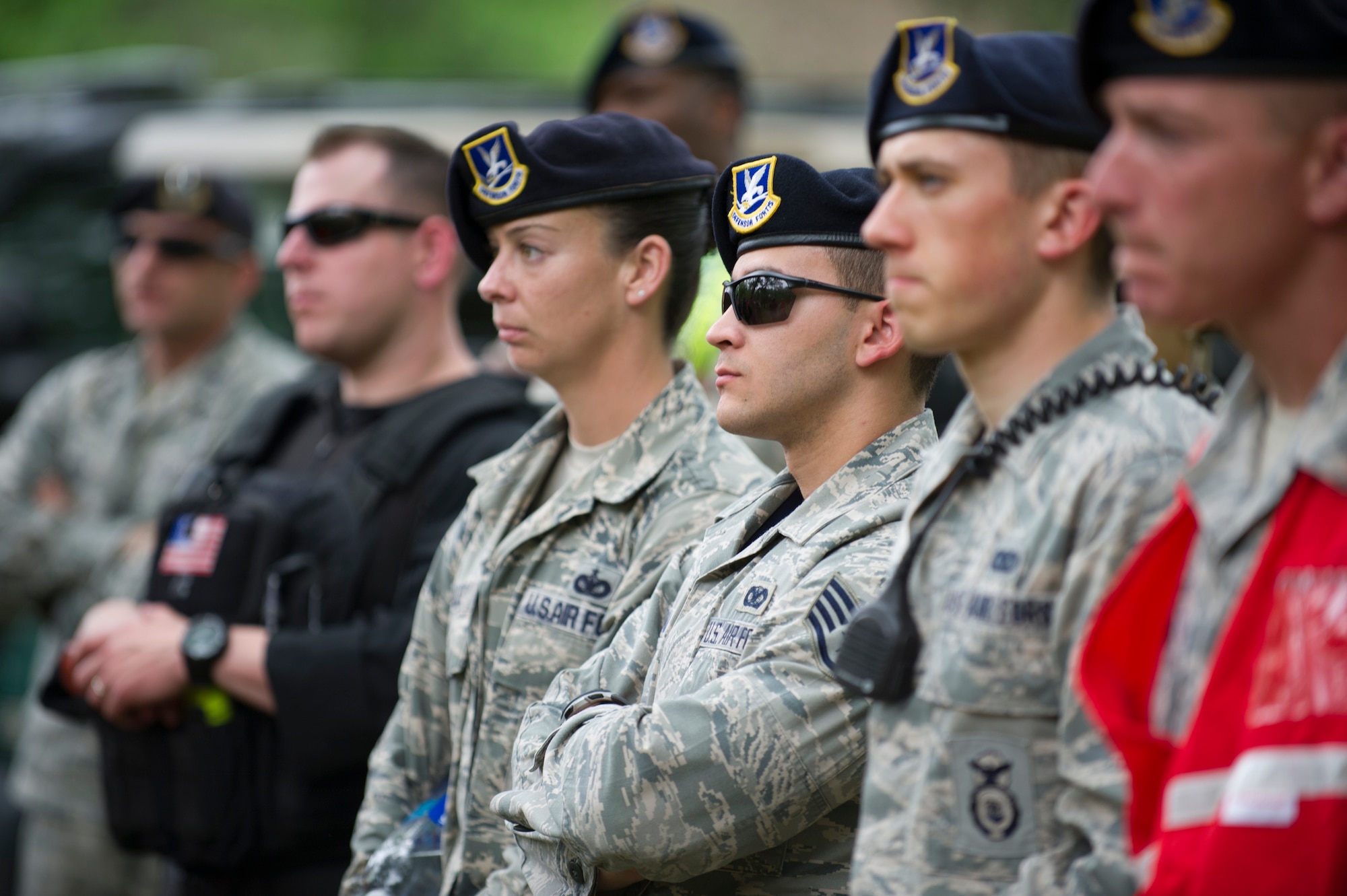 Members of 811th Security Forces Squadron Protective Services listen to a training scenario recap during a contingency response exercise held by Joint Base Andrews and the United States Secret Service. (U.S. Air Force Photo/Staff Sgt. Robert Cloys)
