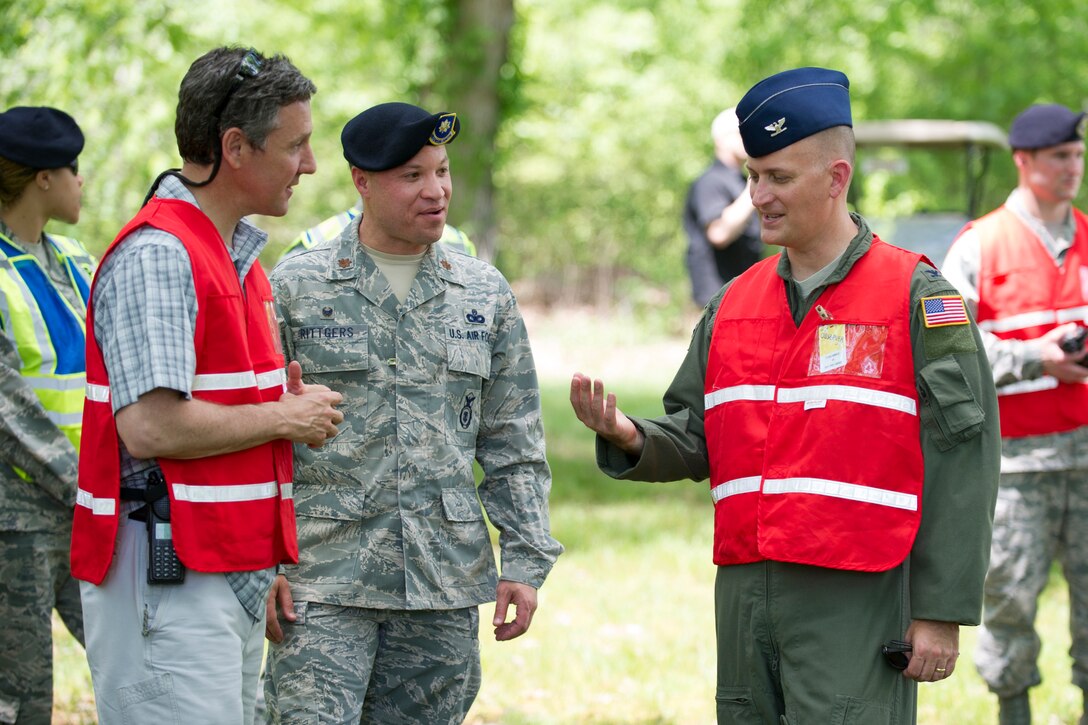 Col. Bill Knight, 11th Wing/Joint Base Andrews commander (right), discusses a training scenario with United States Secret Service Special Agent Rob Donahue (left) and Major Aaron Rittgers (middle), 811th Security Forces Squadron commander, on The Courses at Andrews.  The two-day training was the first large-scale contingency response exercise between Joint Base Andrews and the USSS. (U.S. Air Force Photo/Staff Sgt. Robert Cloys)