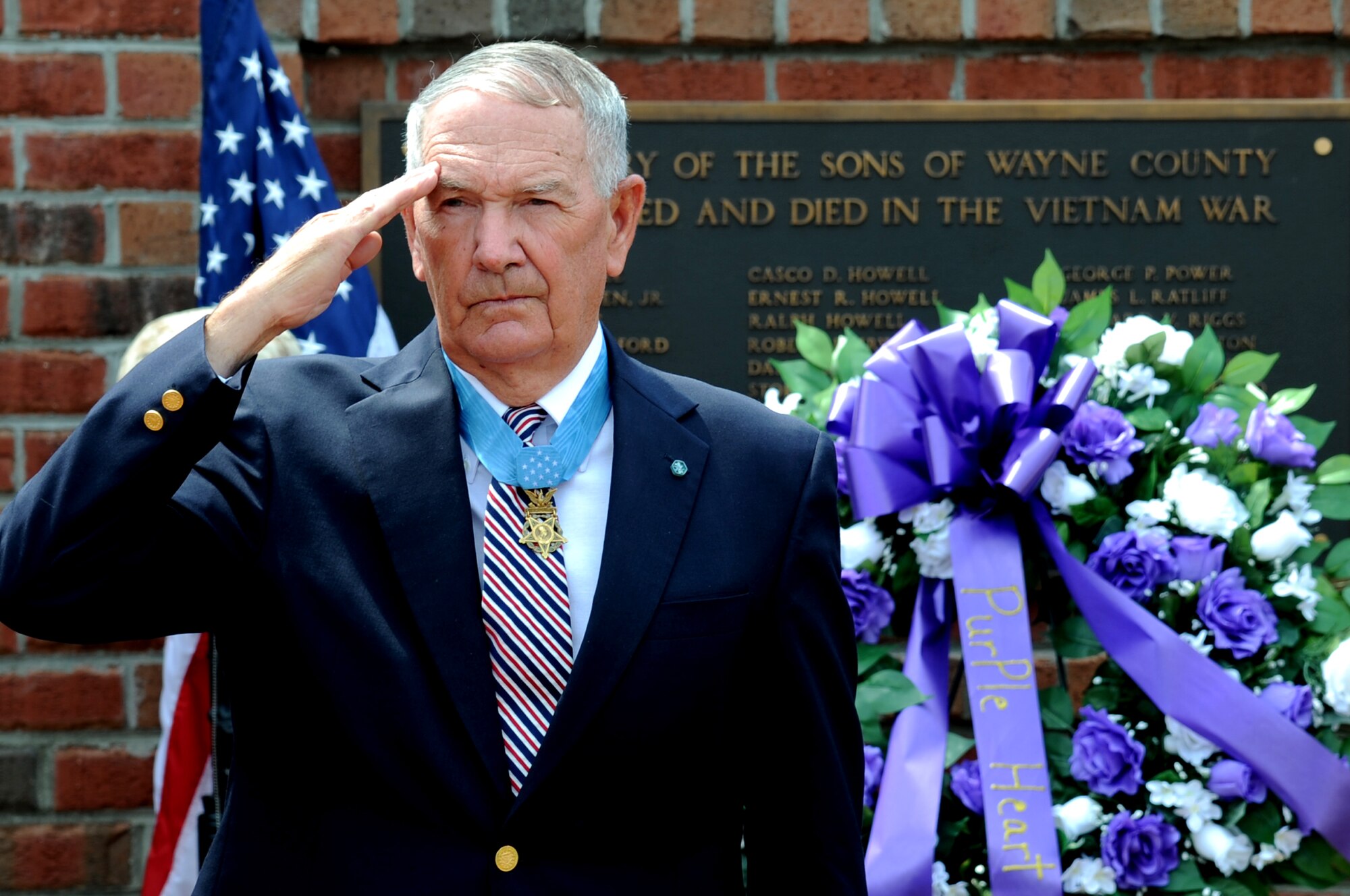 Retired U.S. Army Col. Walter Marm, Jr., Medal of Honor recipient, salutes during taps, May 26, 2014, at the Wayne County Veteran’s Memorial in Goldsboro, North Carolina. Marm spoke about the events he encountered during his time in Vietnam and how he earned the Medal of Honor. (U.S. Air Force photo/Senior Airman Mariah Tolbert)