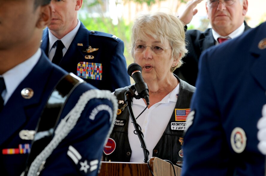 Kris Brewer, soloist, sings the National Anthem, as members of the 4th Fighter Wing Honor Guard present the colors, May 26, 2014, during the observance of the National Moment of Silence at the Wayne County Veteran’s Memorial in Goldsboro, North Carolina. The Moment of Silence encourages all Americans to pause on Memorial Day to honor and remember those who have died in service to the nation. (U.S. Air Force photo/Senior Airman Mariah Tolbert)