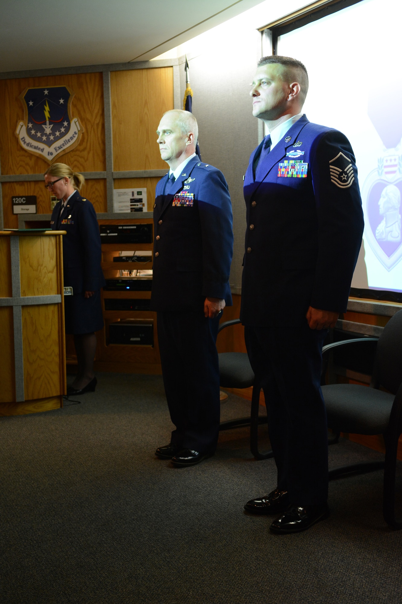 Brig. Gen. Gary L. Ebben, Wisconsin's assistant adjutant general for Air, and Master Sgt. Joshua Johnson, 115th Fighter Wing budget analyst, stand tall during a Purple Heart medal ceremony at the 115 FW in Madison, Wis., May 3, 2014. Johnson was awarded the medal after being thrown from his gunner’s seat and injured during a 2005 deployment. (Air National Guard photo by Senior Airman Andrea F. Liechti)
