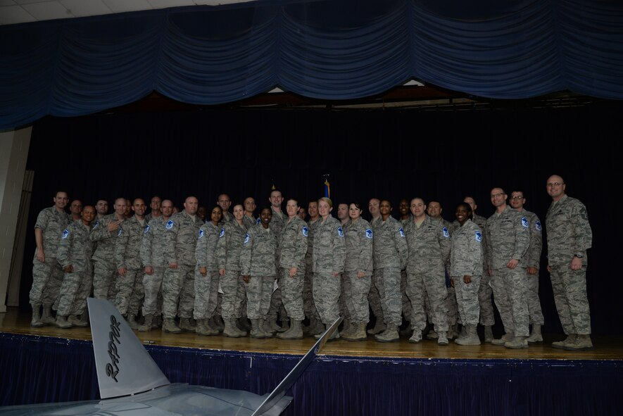 U.S. Air Force Master Sgt. selects from across the 20th Fighter Wing pose for a photo with Col. Scott Arcuri, 20th Mission Support Group commander (far left), and Chief Master Sgt. Charlie Mills, 20th Fighter Wing commander chief (far right), at the community center at Shaw Air Force Base, S.C., May 22, 2014. 33 technical sergeants at Shaw made the cut to be promoted. (U.S. Air Force photo by Airman 1st Class Jonathan Bass/Released)