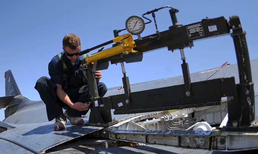 U.S. Air Force Staff Sgt. Billy Trusty Jr., 7th Aircraft Maintenance Squadron B-1B Lancer crew chief, installs a spring panel press on a B-1B Lancer May 20, 2014, at Dyess Air Force Base, Texas. After an in-depth process that included a 200-part questionnaire, background check and an official photo, Trusty was selected for the Presidential Support Team at Andrews Air Force Base, Md. (U.S. Air Force photo by Airman 1st Class Kedesha Pennant/Released)