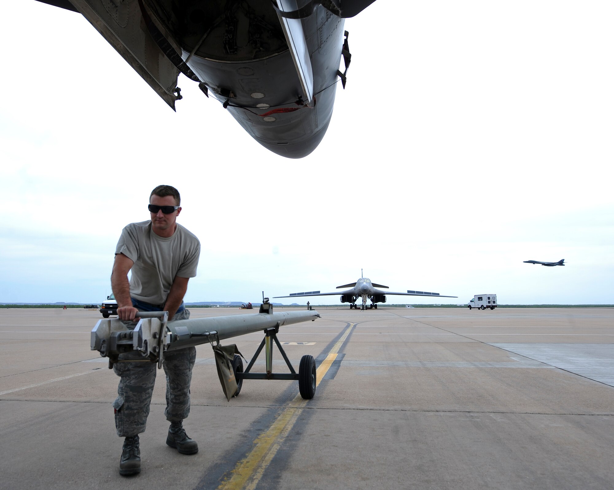 U.S. Air Force Staff Sgt. Billy Trusty Jr., 7th Aircraft Maintenance Squadron B-1B Lancer crew chief, hooks a tow bar to a B-1 May 19, 2014, at Dyess Air Force Base, Texas. Trusty was recently selected for an assignment to the 89th Airlift Wing Presidential Logistics Squadron to perform maintenance on Air Force One at Andrews Air Force Base, Md. (U.S. Air Force photo by Airman 1st Class Kedesha Pennant/Released)
