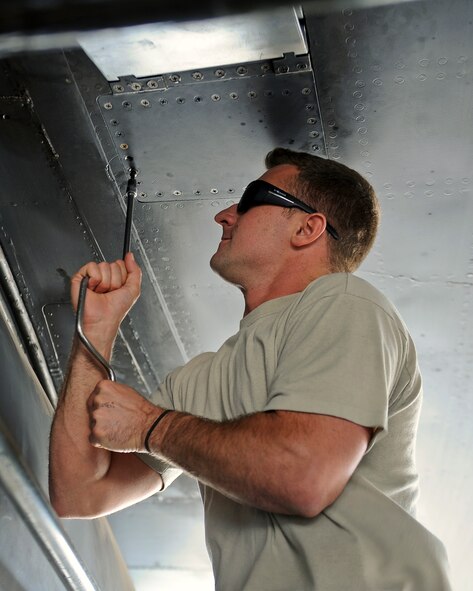 U.S. Air Force Staff Sgt. Billy Trusty Jr., 7th Aircraft Maintenance Squadron B-1B Lancer crew chief, installs a ram air scoop used to cool fuel during flights May 19, 2014, at Dyess Air Force Base, Texas. Trusty joined the Air Force at the age of 19 and has been working on B-1s at Dyess since 2007. (U.S. Air Force photo by Airman 1st Class Kedesha Pennant/Released)