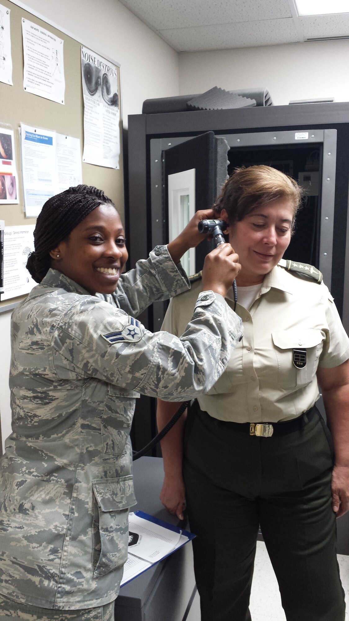 Airman 1st Class Sierra Mack, 22nd Aerospace Medicine Squadron public health technician, examines a patient, May 27, 2014, at McConnell Air Force Base, Kan. Mack educates Airmen about correct sanitary procedures and inspects food service and public facilities for sanitary standards. (Courtesy photo)
