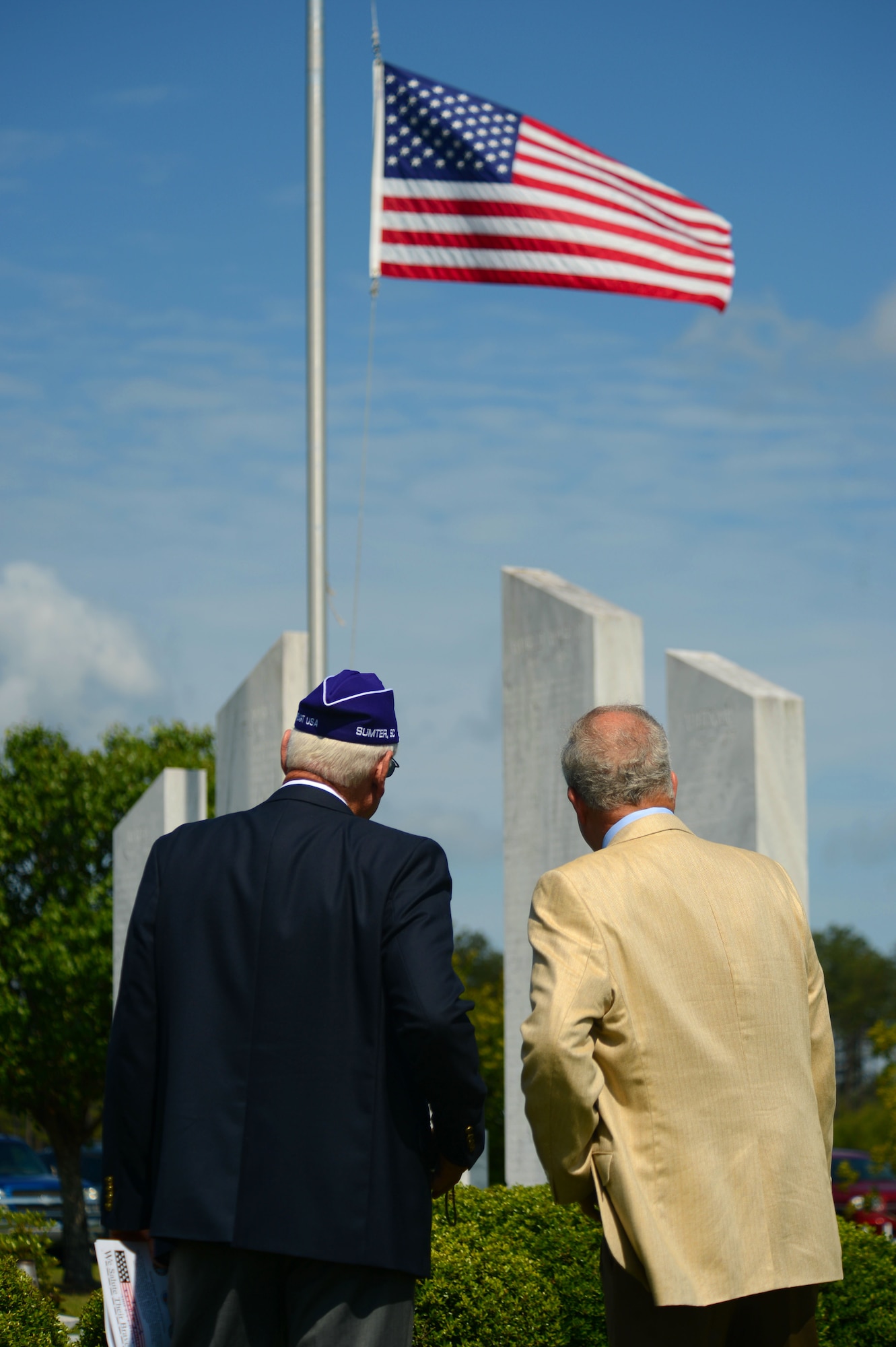 Two spectators look at a memorial wall during a Memorial Day ceremony at Buford Mabry Park, Sumter S.C., May 26, 2014. More than 150 people gathered together to remember the men and women of the armed forces who have died in the line of duty. (U.S. Air Force photo by Airman 1st Class Jensen Stidham/Released)