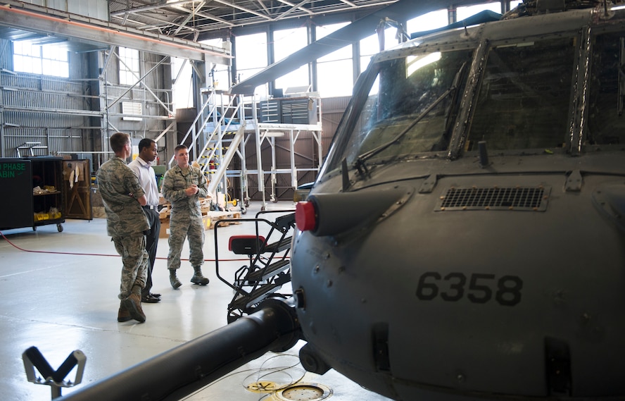Airmen and Pepsi Co. Inc. employees talk in an HH-60G Pave Hawk hangar at Moody Air Force Base, Ga., May 20, 2014. The visit was hosted by the Logistics Officers Association, a military organization that provides an open forum to promote quality logistical support and logistics officer professional development. (U.S. Air Force photo by Senior Airman Jarrod Grammel/Released)
