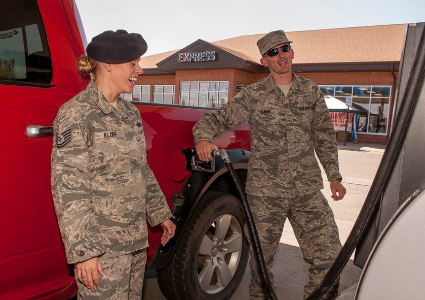 Tech. Sgt. Gina Klopf, 91st Missile Security Forces Squadron assistant flight chief, is surprised with $20 of free gas by Master Sgt. Christopher Davis, 5th Communication Squadron 1st sergeant as part of an Operation Warm Heart initiative at Minot Air Force Base, N.D., May 22, 2014. The 1st sergeants involved in the event gave away free $20 increments of gas beginning at noon and continuing until they reached $1000. (U.S. Air Force photo/Senior Airman Stephanie Sauberan)