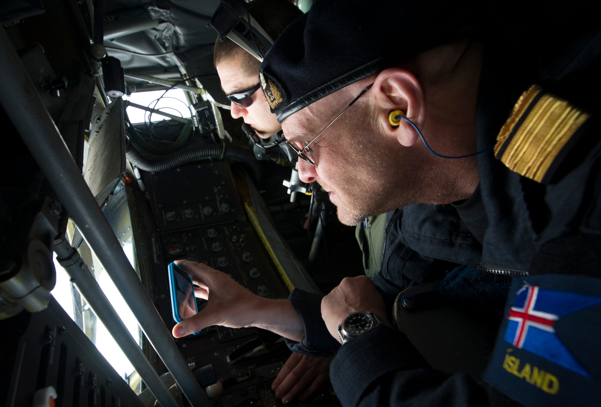KEFLAVIK, Iceland -- Director General of the Icelandic Coast Guard Georg Larusson watches as Tech. Sgt. Joseph Blakely, KC-135 Stratotanker boom operator, offloads fuel during a mission near Keflavik International Airport May 27, 2014. Larusson flew on the mission to view first-hand the U.S.-led Icelandic Air Policing mission currently happening there. (U.S. Air Force photo/Tech. Sgt. Benjamin Wilson)(Released)