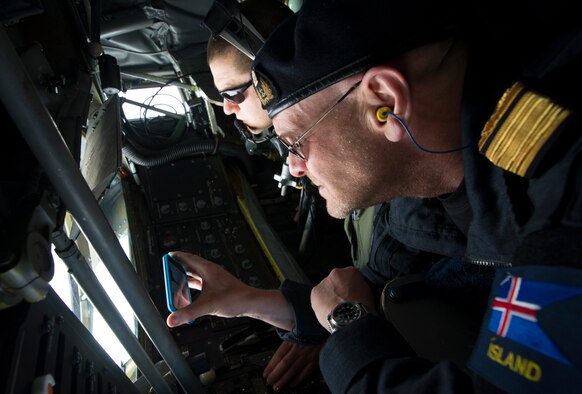Director General of the Icelandic Coast Guard Georg Larusson watches as U.S. Air Force Tech. Sgt. Joseph Blakely, KC-135 Stratotanker boom operator from RAF Mildenhall, England, offloads fuel May 27, 2014, during a mission near Keflavik International Airport in Iceland.  Larusson flew on the mission to view first-hand the U.S.-led Icelandic Air Policing mission currently happening there. (U.S. Air Force photo by Tech. Sgt. Benjamin Wilson/Released) 