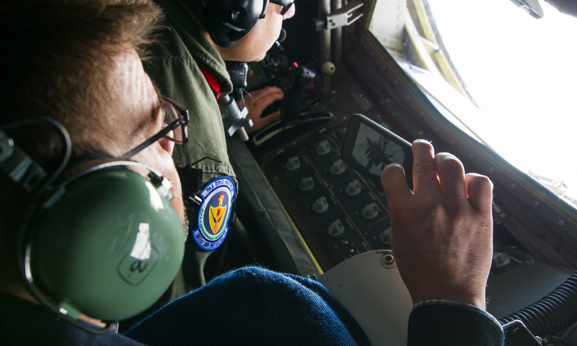 KEFLAVIK, Iceland -- Icelandic Minister of Foreign Affairs Gunnar Sveinsson takes a photo with his cell phone as Tech. Sgt. Joseph Blakely, KC-135 Stratotanker boom operator, offloads fuel to an F-15C Eagle during a mission near Keflavik International Airport May 27, 2014. The minister flew on the mission to view first-hand the U.S.-led Icelandic Air Policing mission currently happening there. (U.S. Air Force photo/Tech. Sgt. Benjamin Wilson)(Released)