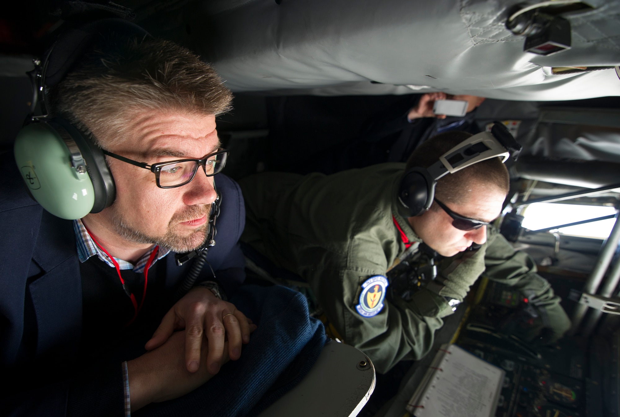 KEFLAVIK, Iceland -- Icelandic Minister of Foreign Affairs Gunnar Sveinsson watches as Tech. Sgt. Joseph Blakely, KC-135 Stratotanker boom operator, offloads fuel during a mission near Keflavik International Airport May 27, 2014. The minister flew on the mission to view first-hand the U.S.-led Icelandic Air Policing mission currently happening there. (U.S. Air Force photo/Tech. Sgt. Benjamin Wilson)(Released)