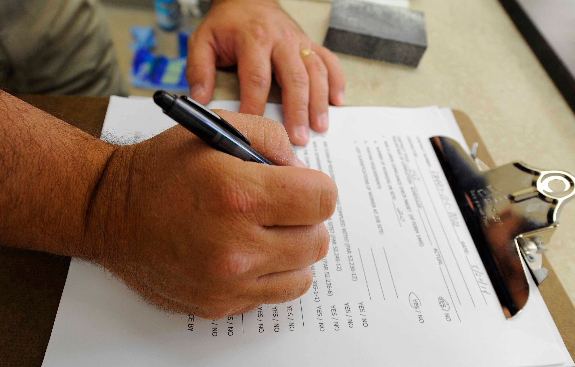 Todd Davis, 1st Special Operations Contracting Squadron contracting specialist, conducts a survey at Hurlburt Field, Fla. May 20, 2014. Davis surveyed workers about materials used during construction of a new back gate for Hurlburt Field. (U.S.  Air Force photo/Airman 1st Class Andrea Posey)