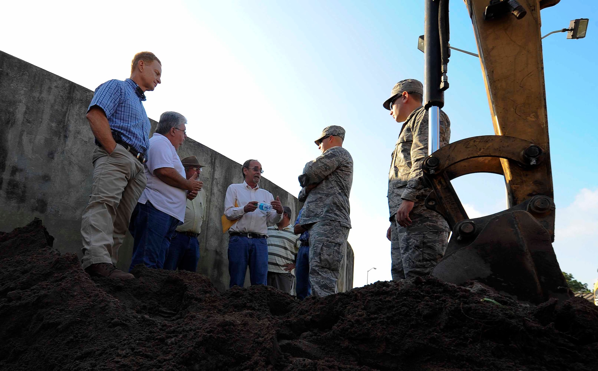 Tech. Sgt. Timothy Emeott, 1st Special Operations Contracting Squadron contracting officer, and Senior Airman William Farr, 1st SOCONS contracting specialist, speak to a contracted team at Hurlburt Field, Fla., May 21, 2014. The 1st SOCONS supervises construction of various projects on Hurlburt Field. (U.S.  Air Force photo/Airman 1st Class Andrea Posey)