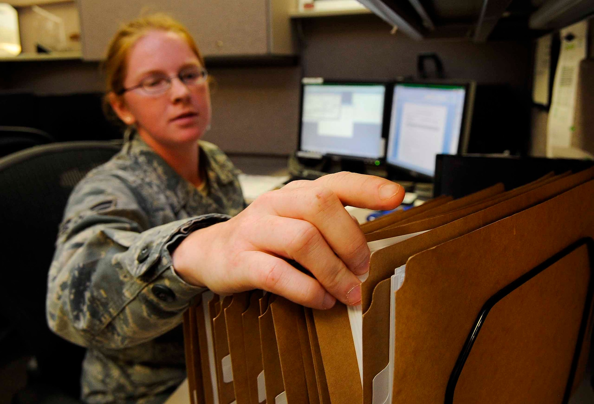 Airman 1st Class Heaven Carroll, 1st Special Operations Contracting Squadron contracting specialist, sorts through folders at Hurlburt Field, Fla., May 20, 2014. The 1st SOCONS provides support including negotiating, awarding and administering Hurlburt Field’s commodity, service and construction requirements. (U.S.  Air Force photo/Airman 1st Class Andrea Posey)
