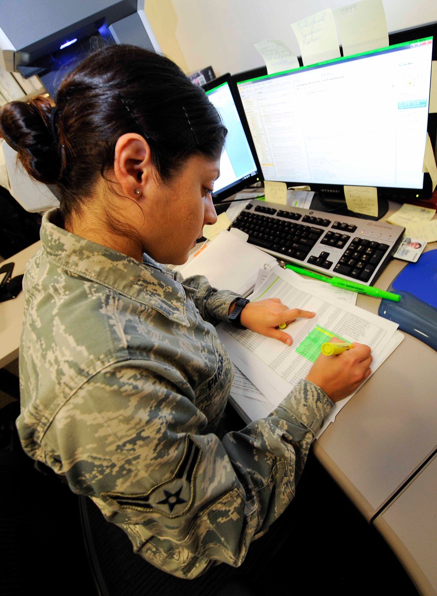 Airman 1st Class Gladys Pargas, 1st Special Operations Contracting Squadron contracting specialist, checks over Airmen’s spending records at Hurlburt Field, Fla., May 20, 2014. The 1st SOCONS monitor and manage Hurlburt Field’s Government Purchase Card Program. (U.S.  Air Force photo/Airman 1st Class Andrea Posey)