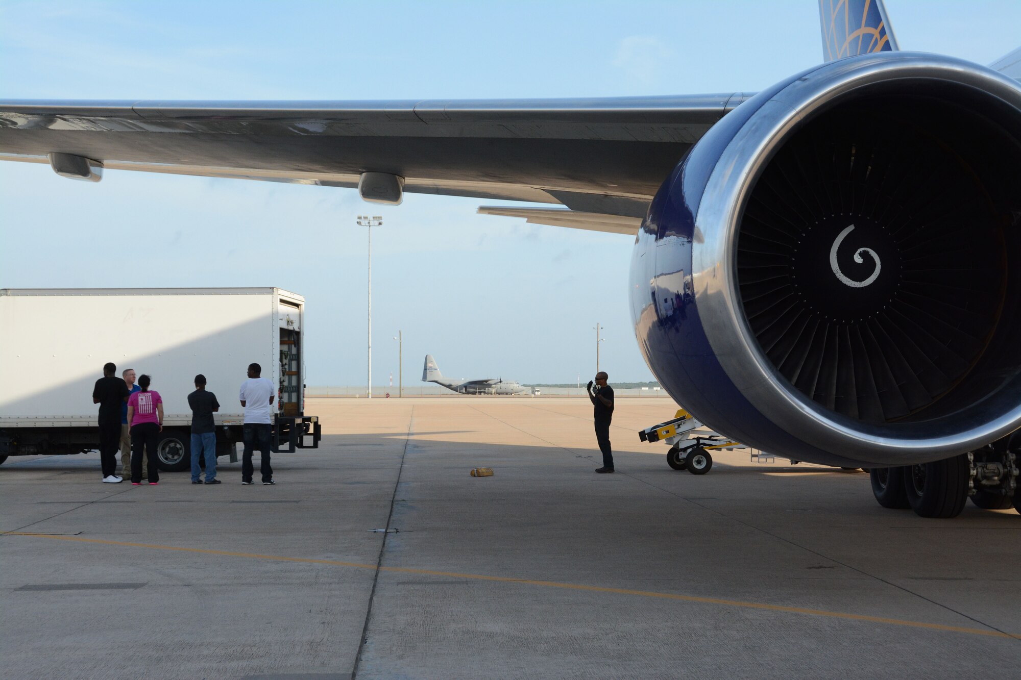 Members of the 301st, 307th, and 610th Security Forces squadrons wait to load luggage onto a jet bound for Jordan at Naval Air Station Fort Worth Joint Reserve Base, May 20, 2014. They are deploying in support of Eager Lion, which includes more than 12,500 military and civilian participants from five continents, according to U.S. Central Command, and focuses on strengthening the military-to-military relationships and further demonstrates the U.S. commitment to regional security and stability. (U.S. Air Force photo by Staff Sgt. Samantha Mathison)
