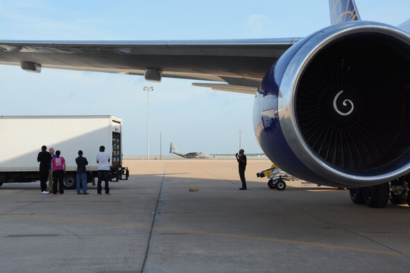 1.	Members of the 301st, 307th and 610th Security Forces Squadrons wait to load luggage onto a jet bound for Jordan May 20, 2014, Naval Air Station Fort Worth Joint Reserve Base, Texas. They deployed in support of Eager Lion, an exercise which focused on strengthening military-to-military relationships and demonstrated the U.S. commitment to regional security and stability, according to U.S. Central Command. (U.S. Air Force photo by Staff Sgt. Samantha Mathison)