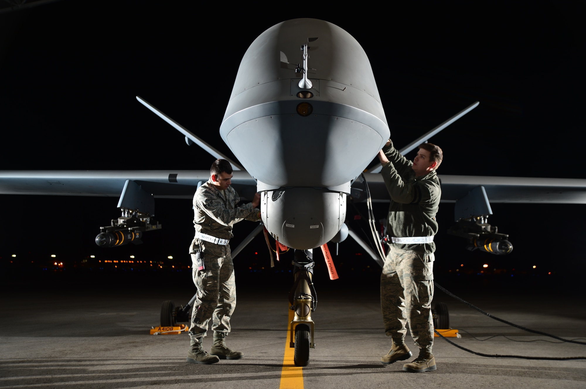Airman 1st Class Steven, 432nd Aircraft Maintenance Squadron MQ-9 Reaper crew chief (left), and Airman 1st Class Taylor, 432nd Aircraft Maintenance Squadron MQ-9 Reaper crew chief (right), prepare an MQ-9 Reaper for flight during Combat Hammer May 15, 2014, Creech Air Force Base, Nev. Fighter, bomber and remotely piloted aircraft units around the Air Force are evaluated four times a year and provided weapons, airspace and targets from Hill AFB, Utah, or Eglin AFB, Fla. (U.S. Air Force photo by Staff Sgt. N.B./Released)