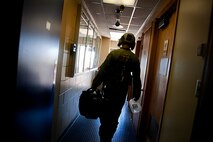 Staff Sgt. Jake Gornbein, 54th Helicopter Squadron special missions aviator instructor, walks out of the squadron building before take-off at Minot Air Force Base, N.D., May 13, 2014. Gorbein is a native of South Windsor, Connecticut, and has been in the Air Force for seven years. (U.S. Air Force photo/Senior Airman Brittany Y. Bateman)