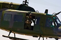 Staff Sgt. Daniel Vehslage, 54th Helicopter Squadron special missions aviator instructor, looks out the side of a UH-1N Huey at Minot Air Force Base, N.D., May 13, 2014. Special mission aviation, a fairly new career field, was split off from flight engineers to create specialized Airmen. (U.S. Air Force photo/Senior Airman Brittany Y. Bateman)
