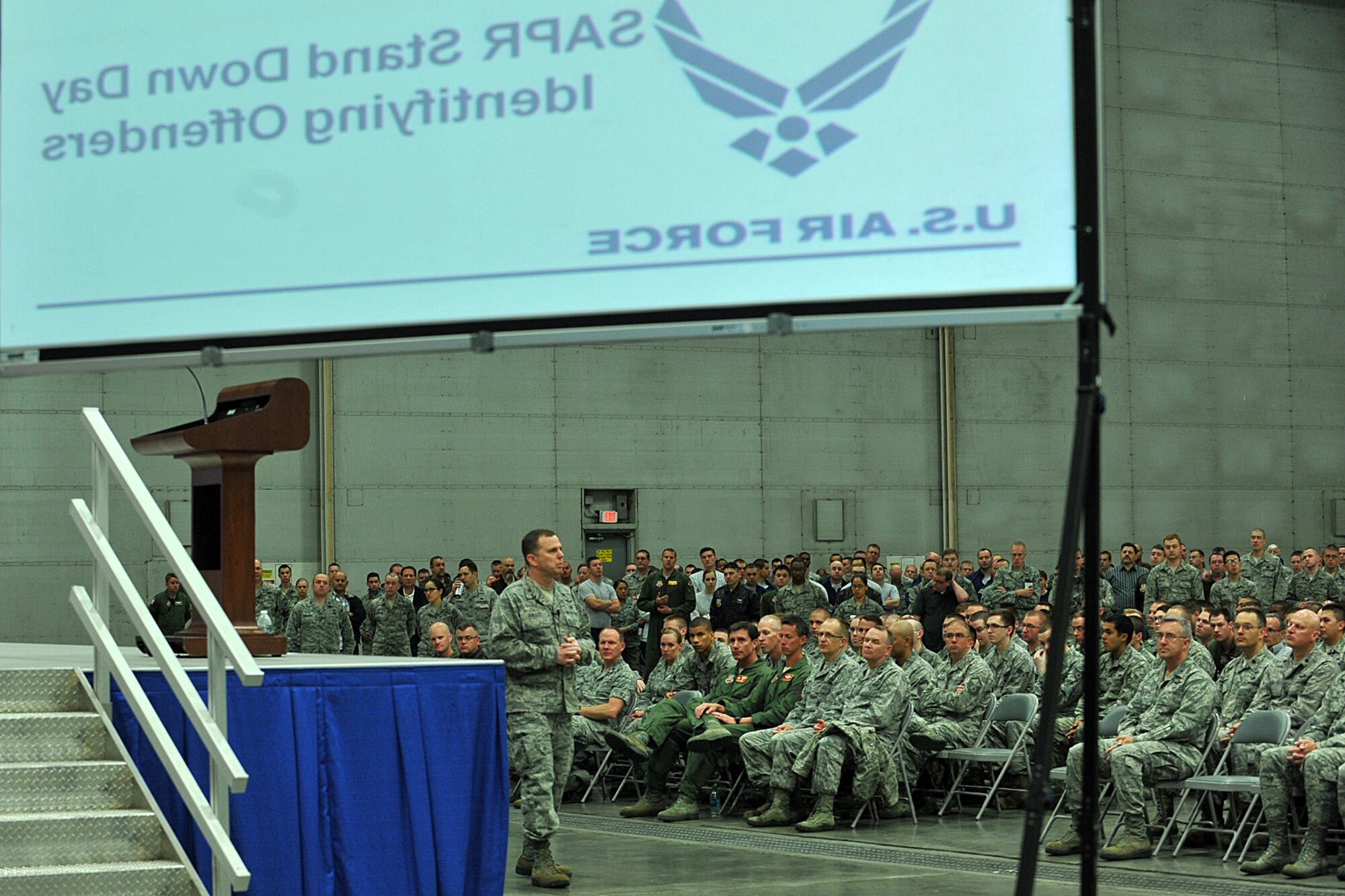 Members of the 55th Wing line the walls of Dock 1 of the Bennie Davis Maintenance Facility to listen to U.S. Air Force Col. Gregory Guillot, 55th Wing commander, during a commander’s call for Comprehensive Airman Fitness Day at Offutt Air Force Base, Neb., May 22. CAF days allow members of the 55th Wing to come together and receive much needed refresher training in a group setting as well as focus on the four aspects of CAF, physical, mental, social and spiritual.