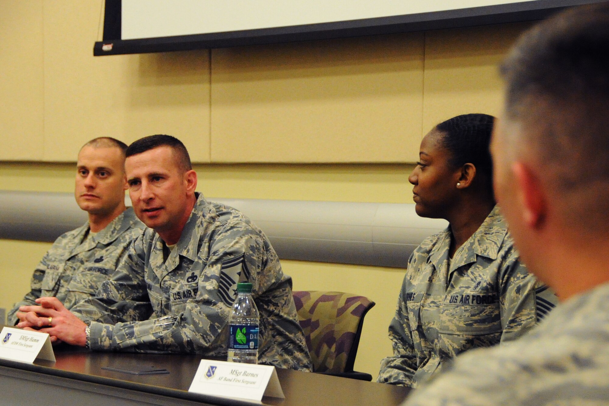 (Left to right) Master Sgt. Eric Villafana, 11th Wing first sergeant, Senior Master Sgt. Johnny Hamm, Air Force District of Washington first sergeant, and Master Sgt. Angelique Barnes, Air Force Band first sergeant, speak to officers who have either prior command experience or expect to assume command during the 2014 AFDW Commander’s Course at Joint Base Andrews, Md., May 21, 2014. The course provides information to commanders about force management, resiliency and the total force mission in the National Capital Region. (U.S. Air force photo/Staff Sgt. Matt Davis)