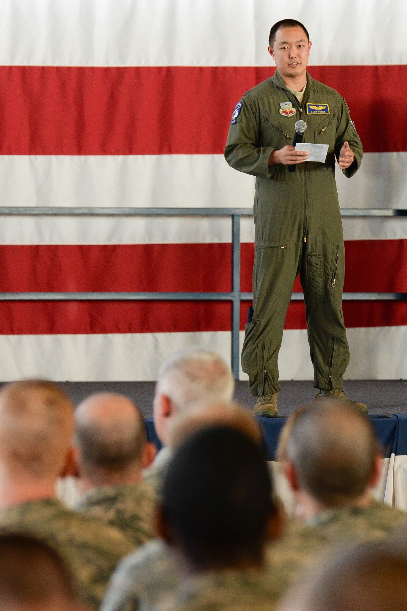 Capt. Gavin O’brien, 28th Bomb Wing chief of safety, speaks to Airmen about staying diligent when it comes to summer safety during a wing commander’s call in the Pride Hangar at Ellsworth Air Force Base, S.D., May 22, 2014. O’brien encouraged Airmen to practice mishap prevention during summer activities. (U.S. Air Force photo by Senior Airman Zachary Hada/Released)