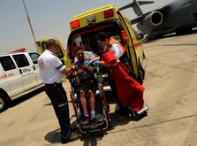 Israel medics assist U.S. Army Private 1st Class James Black, a multi-channel radio operator maintainer assigned to the 44th Signal Battalion at Grafenwoehr, Germany, and Atlanta native, out of a wheelchair-stretcher during a simulated medical evacuation on the flightline of Ben Gurion Airport in Tel Aviv, Israel, May 20, 2014 as part of the Juniper Cobra 14 defense training exercise. The medical evacuation represented the first time the U.S. military relied on a host nation to provide virtually all medical care for American service members.  (U.S. Air Force photo by Staff Sgt. Joe W. McFadden/Released)