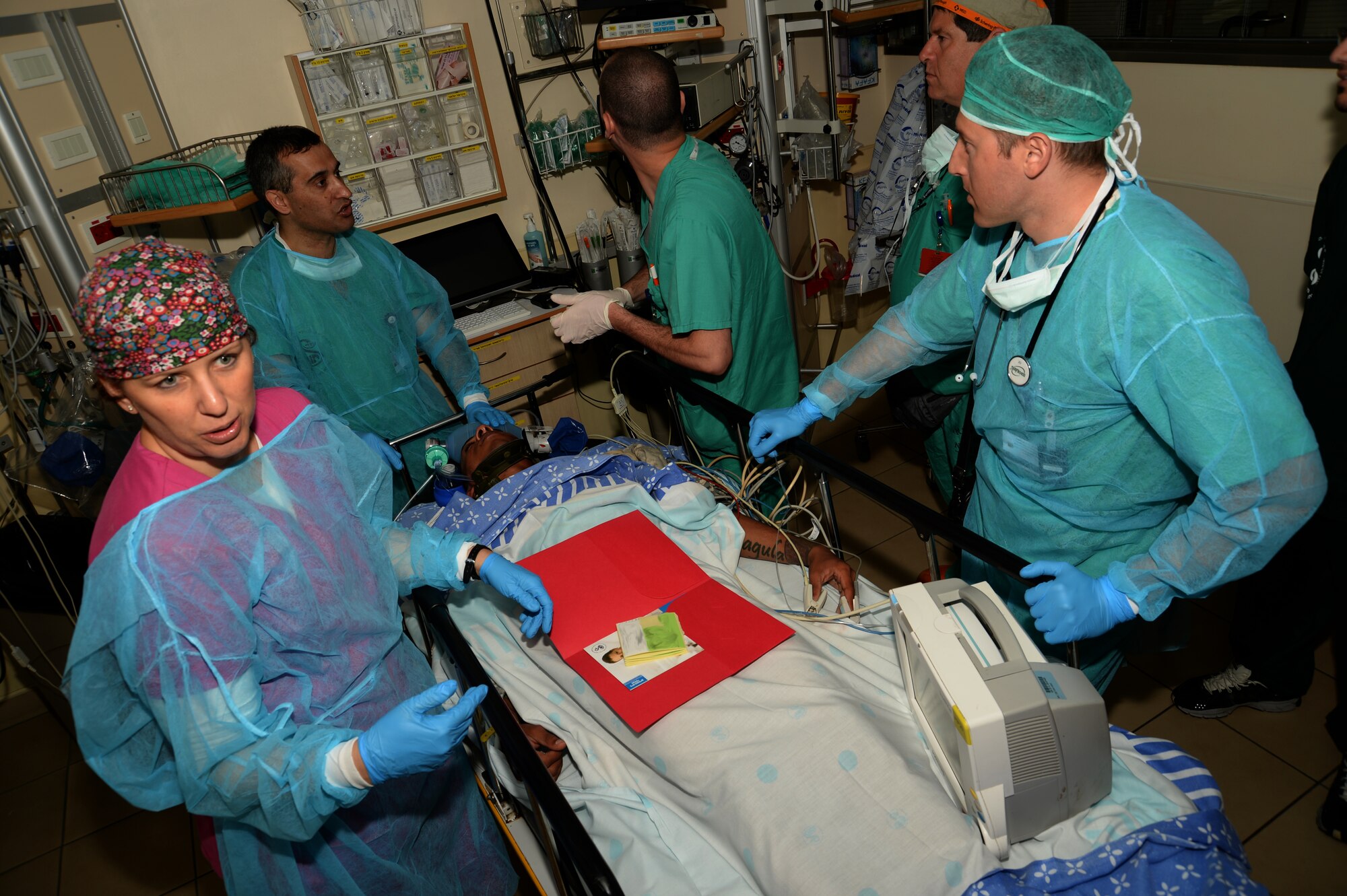 Israeli medics tend to simulated injuries of U.S. Army Private 1st Class James Black, a multi-channel radio operator maintainer assigned to the 44th Signal Battalion at Grafenwoehr, Germany, and Atlanta native, during a simulated medical evacuation at Sheba Medical Center near Beer Sheba, Israel, May 20, 2014. The medical exercise tested both nations' ability to communicate and track transportation of a simulated patient from the scene of an injury to a hospital and to a U.S. military aircraft. (U.S. Air Force photo illustration by Staff Sgt. Joe W. McFadden/Released)