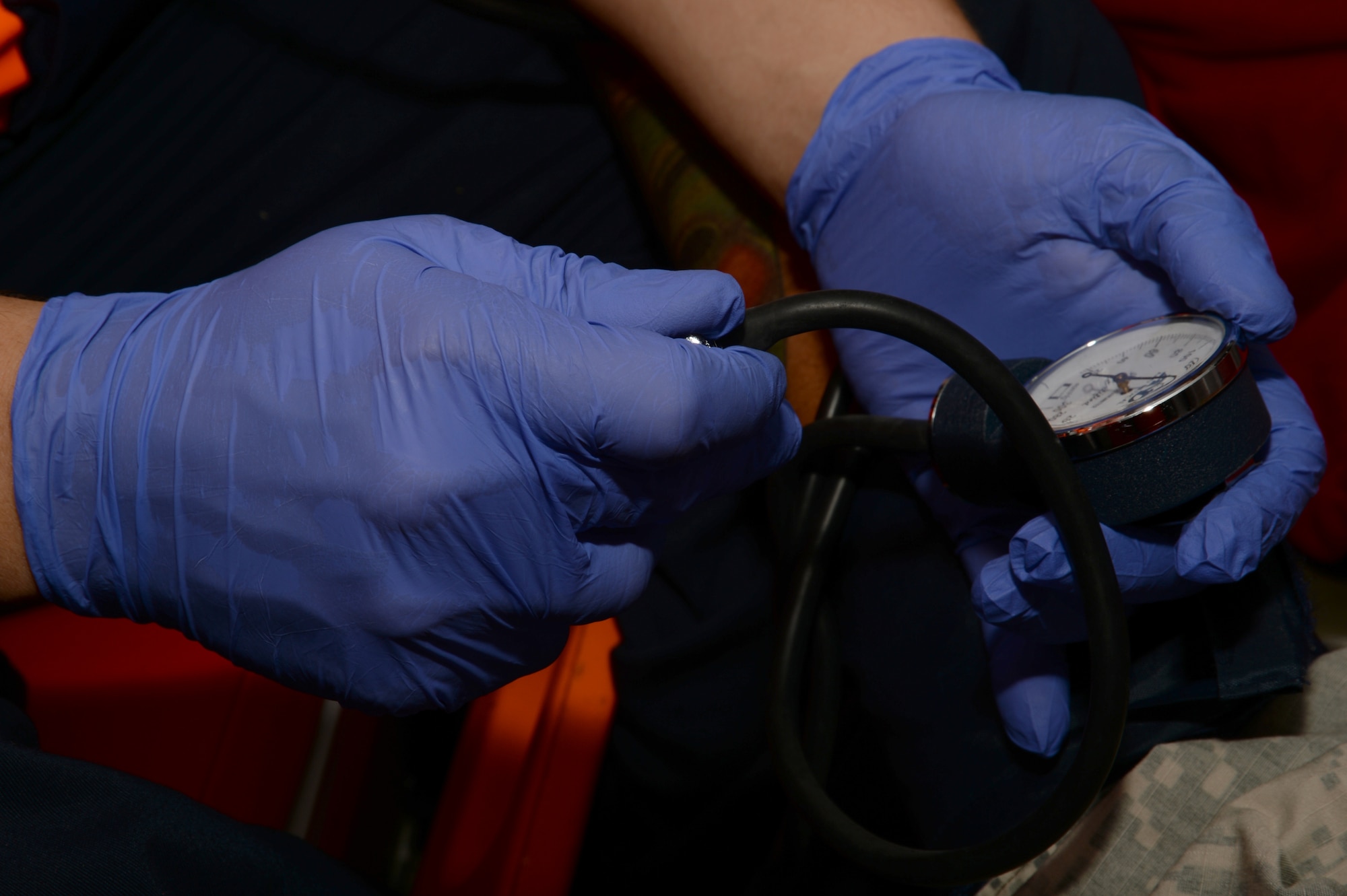 Chen Michael, a Magen David Adom medic, uses a blood pressure pump to check the status of a patient while onboard an ambulance during a simulated medical evacuation as part of the Juniper Cobra 14 defense training exercise in Israel, May 20, 2014. Approximately 2,000 U.S. service members and civilians stationed in Europe and the United States traveled to Israel to participate in JC14 as a training audience or exercise evaluators.  (U.S. Air Force photo by Staff Sgt. Joe W. McFadden/Released)