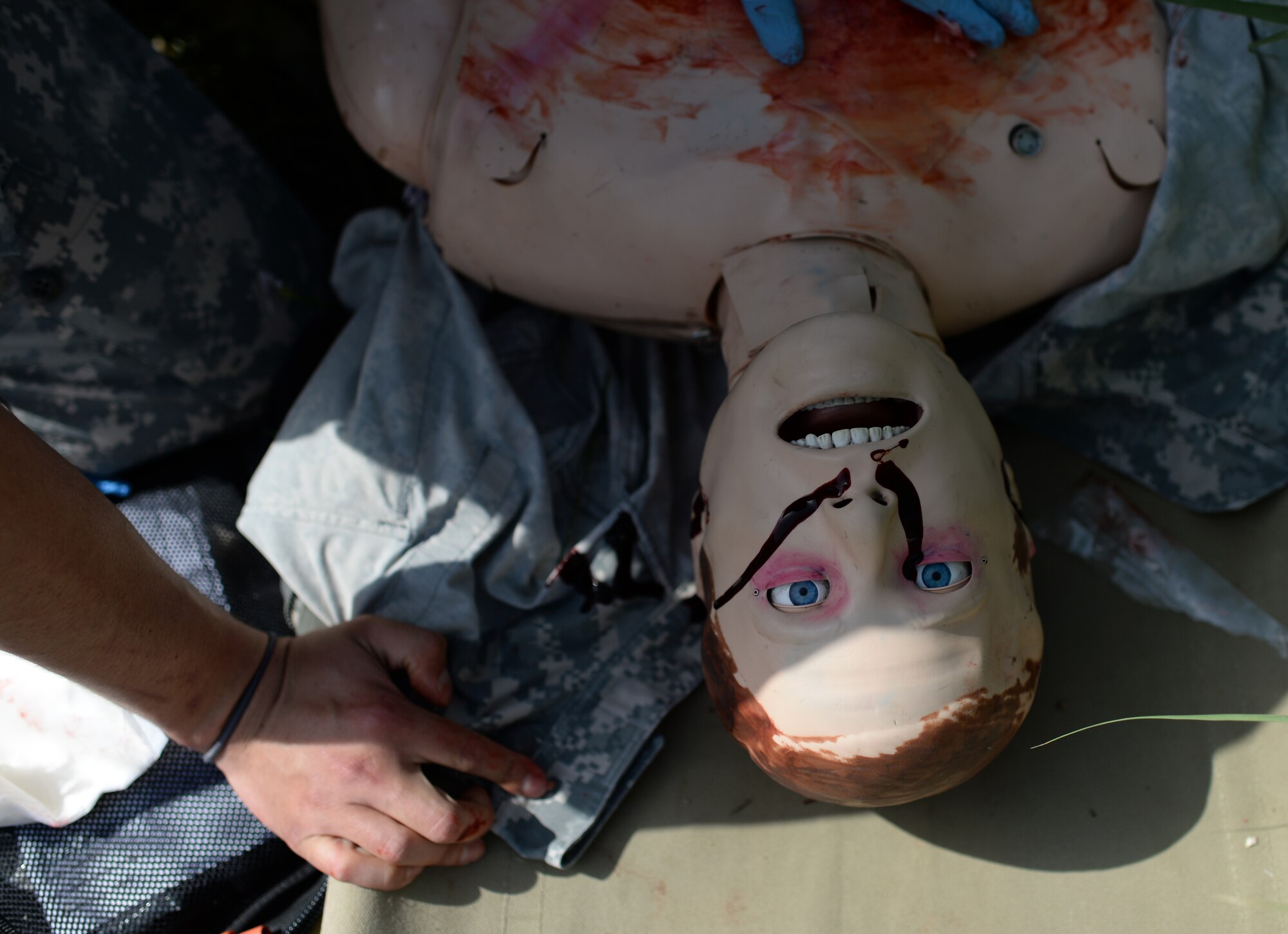 A U.S. medic treats simulated wounds on an electronic medical dummy during a simulated medical evacuation as part of the Juniper Cobra 14 defense training exercise at Hatzor Air Base, Israel, May 20, 2014. The medical exercise tested both nations' ability to communicate and track transportation of a simulated patient from the scene of an injury to a hospital and to a U.S. military aircraft. (U.S. Air Force photo illustration by Staff Sgt. Joe W. McFadden/Released)