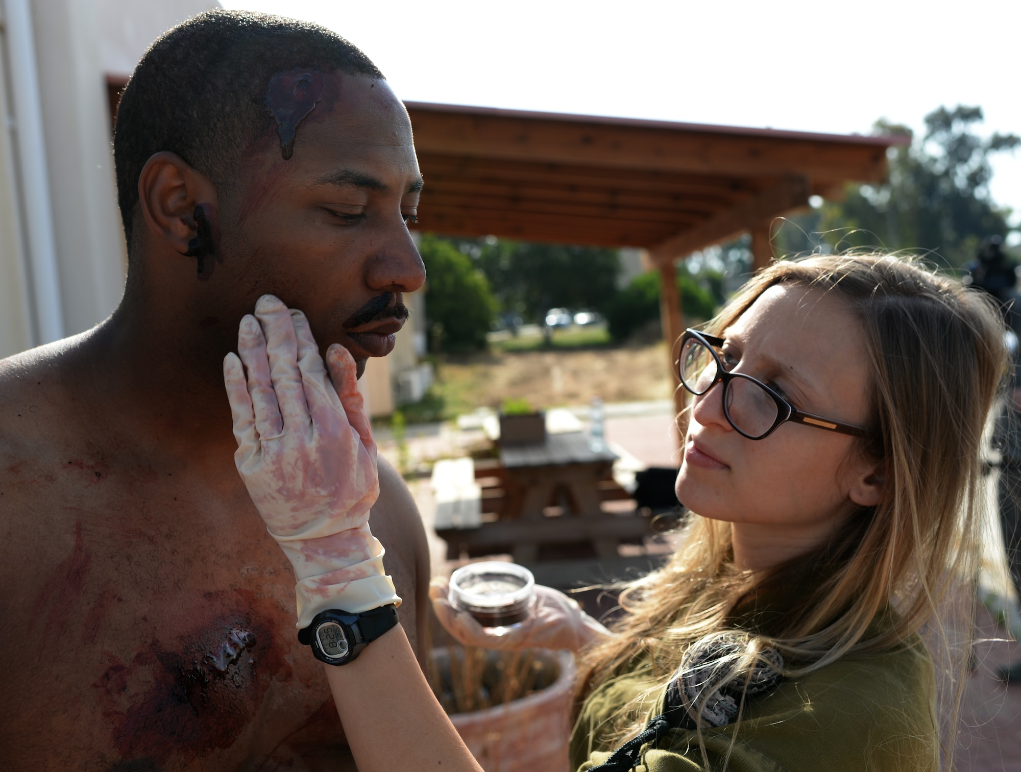 Lital Dan, an Israeli medic, applies makeup to a U.S. Army Staff Sgt. Willie Morgan, a generator mechanic assigned to the 10th Army and Missile Defense Command at Kaiserslautern, Germany, and Atlanta native, during a simulated medical evacuation as part of the Juniper Cobra 14 defense training exercise at Hatzor Air Base, Israel, May 20, 2014. JC14 exercises both countries’ interoperability while maintaining and improving Israel’s defensive capacity. (U.S. Air Force photo by Staff Sgt. Joe W. McFadden/Released)