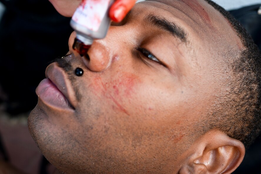 Lital Dan, an Israeli medic, applies makeup to the face of U.S. Army Staff Sgt. Willie Morgan, a generator mechanic assigned to the 10th Army and Missile Defense Command at Kaiserslautern, Germany, and Atlanta native, during a simulated medical evacuation as part of the Juniper Cobra 14 defense training exercise at Hatzor Air Base, Israel, May 20, 2014. JC14 exercises both countries’ interoperability while maintaining and improving Israel’s defensive capacity. (U.S. Air Force photo by Staff Sgt. Joe W. McFadden/Released)