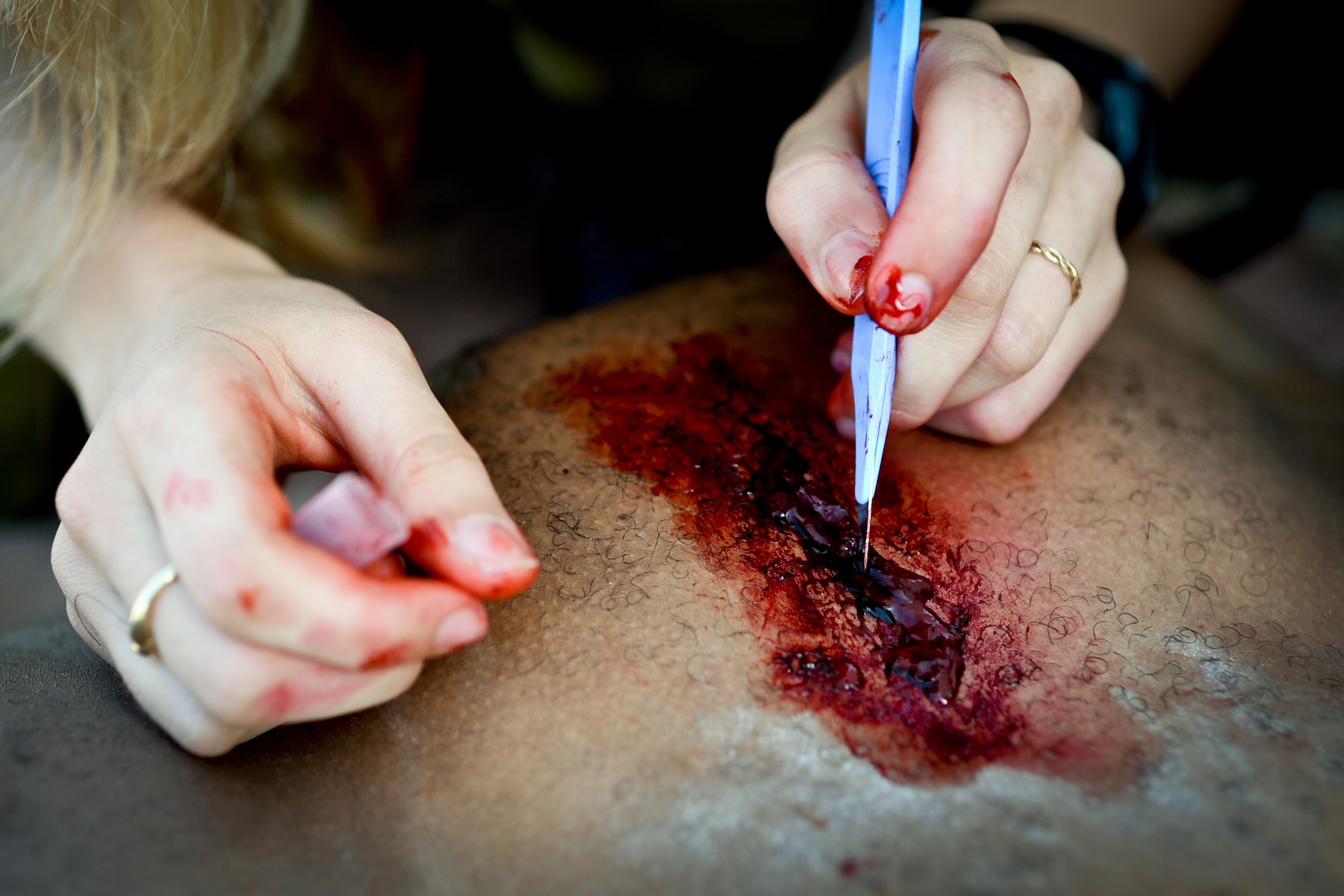 Lital Dan, an Israeli medic, applies makeup to a U.S. Army Staff Sgt. Willie Morgan, a generator mechanic assigned to the 10th Army and Missile Defense Command at Kaiserslautern, Germany, and Atlanta native, during a simulated medical evacuation as part of the Juniper Cobra 14 defense training exercise at Hatzor Air Base, Israel, May 20, 2014. JC14 exercises both countries’ interoperability while maintaining and improving Israel’s defensive capacity. (U.S. Air Force photo by Staff Sgt. Joe W. McFadden/Released)