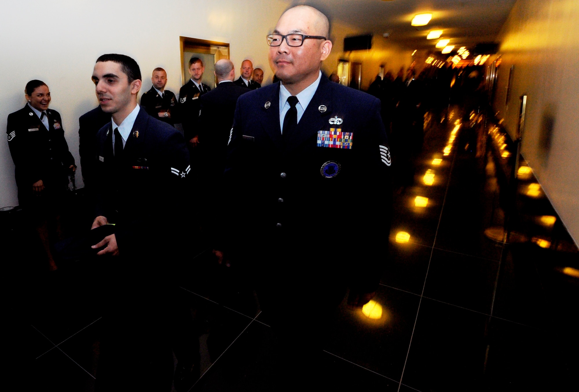 Tech Sgt. Andrew Davis, 514th Air Mobility Wing line recruiter and Airman 1st Class Anthony Vinci, 514th Force Support Squadron member, follow the queue to be escorted into “The Tonight Show” studio at Rockefeller Center in New York City May 23. In recognition of Military Appreciation month, 45 servicemembers from each branch were invited to attend a taping of the show (U.S. Air Force photo/Senior Airman Chelsea Smith)
