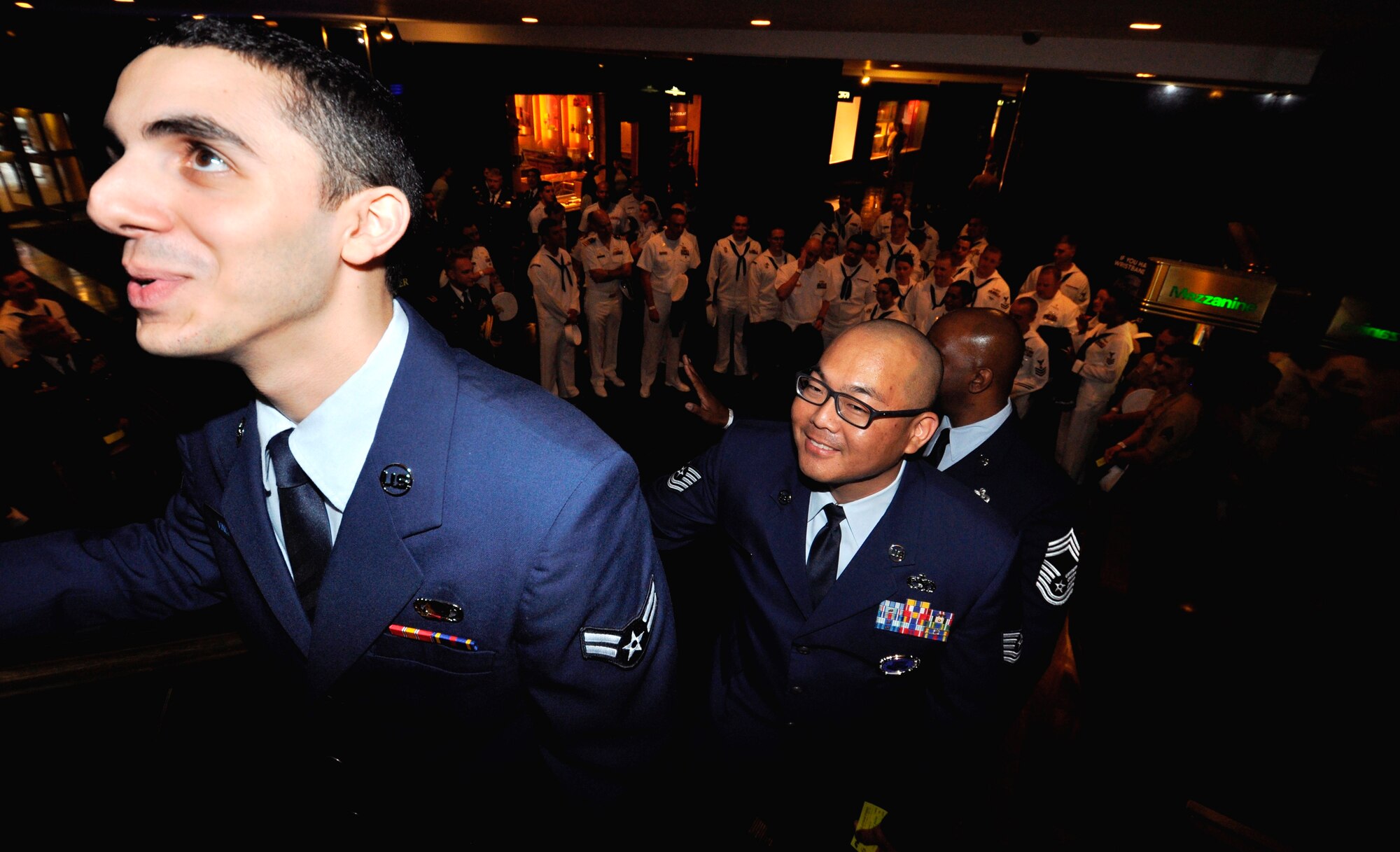 Tech Sgt. Andrew Davis, 514th Air Mobility Wing line recruiter and Airman 1st Class Anthony Vinci, 514th Force Support Squadron member, ride the escalator to “The Tonight Show” studio at Rockefeller Center in New York City May 23. In recognition of Military Appreciation month, 45 servicemembers from each branch were invited to attend a taping of the show (U.S. Air Force photo/Senior Airman Chelsea Smith).
