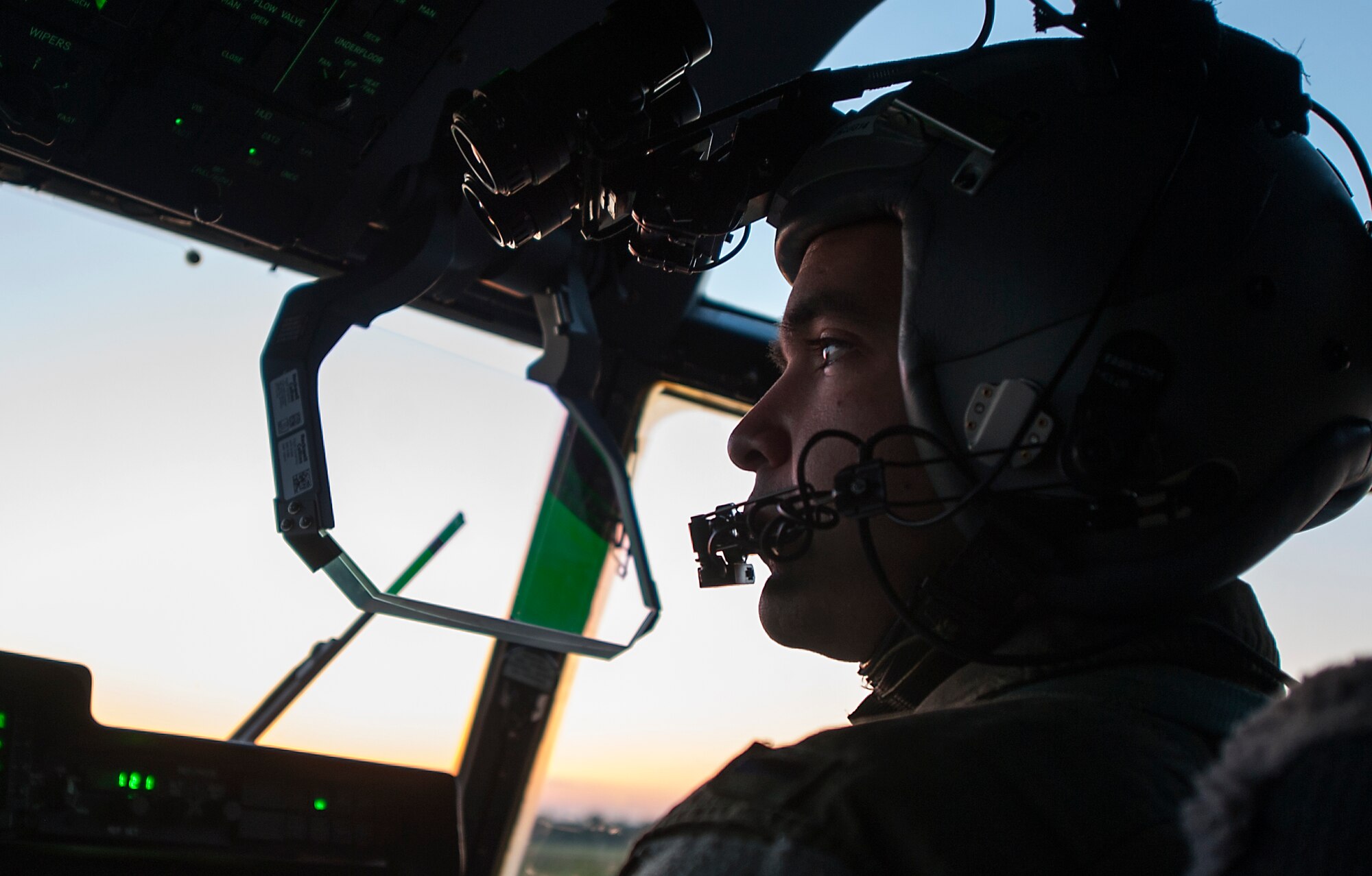 U.S. Air Force 1st Lt. Ben Delacruz, 37th Airlift Squadron pilot, prepares for flight using night-vision goggles during Carpathian Spring 2014 in Bucharest, Romania, May 19, 2014. During the two-week-long training, pilots were able to utilize the less-restrictive airspace, which allowed them to perform low-level and night-vision flights and fulfilled annual training requirements. (U.S. Air Force photo/Senior Airman Damon Kasberg)
