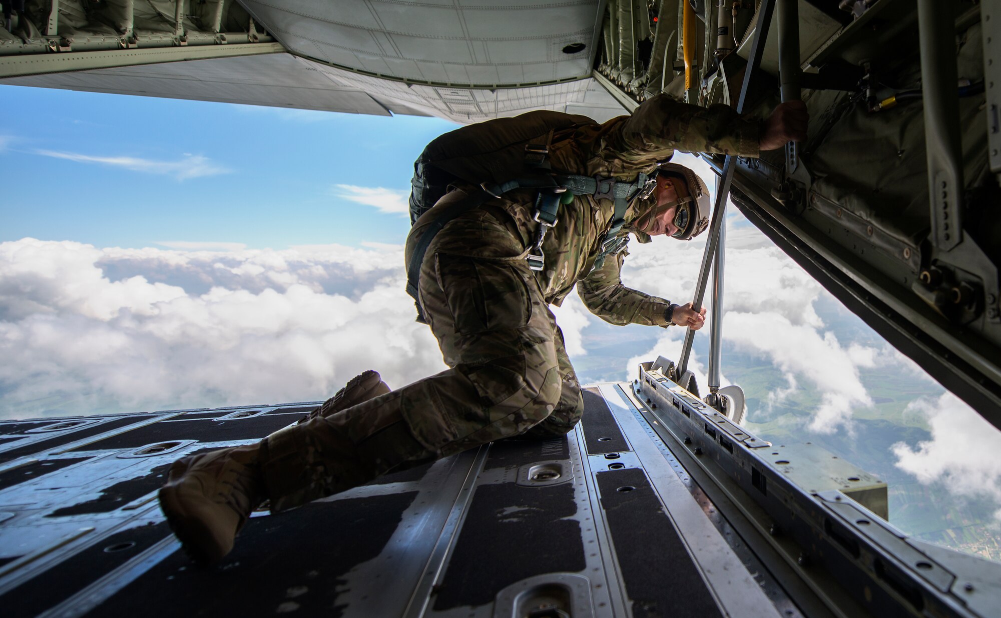 U.S. Army 1st Sgt. Leldon Lee Want, Special Operations Command Europe Joint Special Operations Air Component senior enlisted leader, looks out the back ramp of a U.S. Air Force C-130J Super Hercules to ensure Romanian paratroopers can safely exit the aircraft during Carpathian Spring 2014, May 18, 2014, above Campia Turzii, Romania. Jumpmasters from Ramstein Air Base, Germany and RAF Mildenhall, England took part in the training to help guarantee jumps went smoothly. (U.S. Air Force photo/Senior Airman Damon Kasberg)