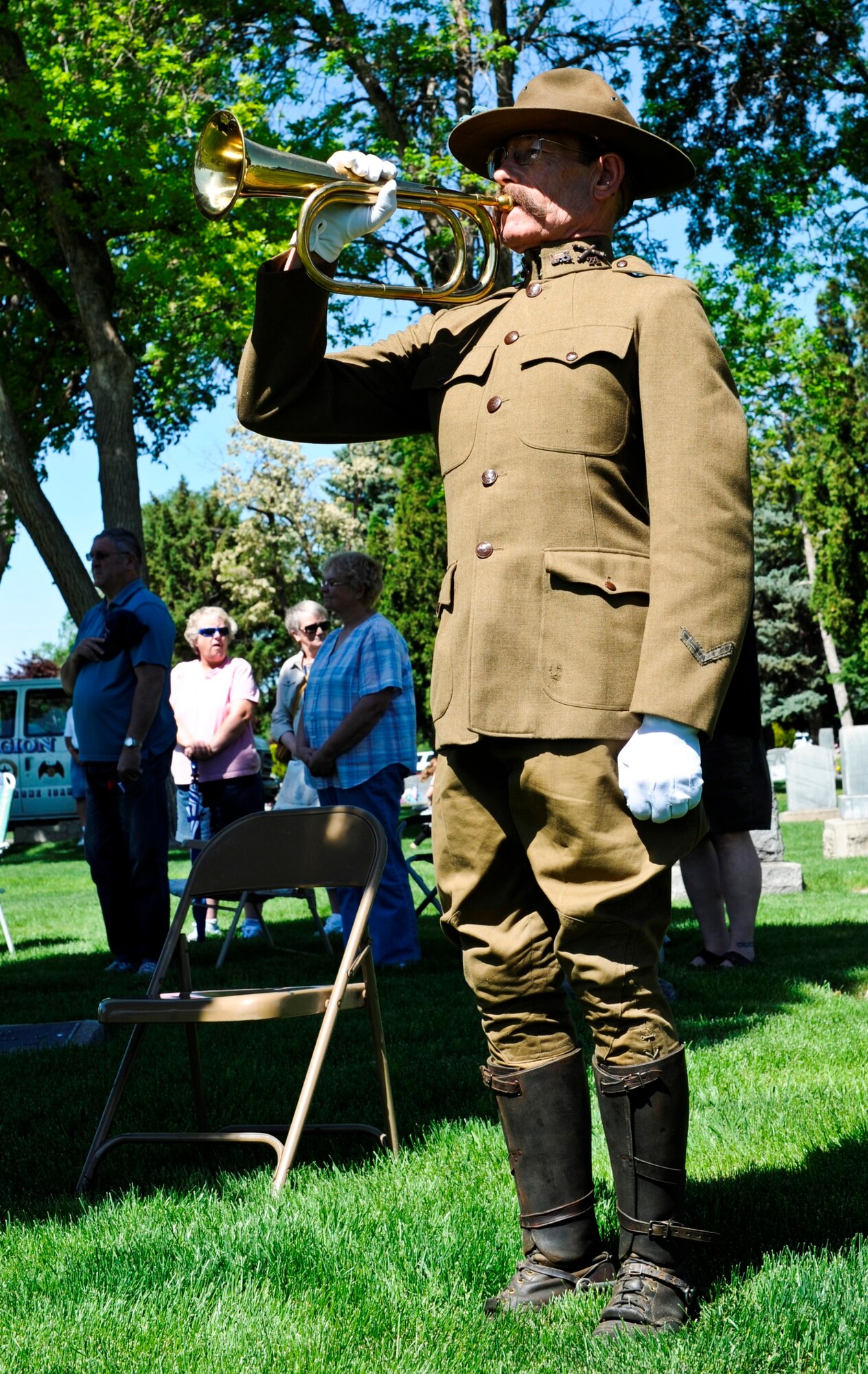 A bugler clad in a World War I uniform plays taps at a Memorial Day observance at Mountain View Cemetery in Mountain Home, Idaho, May 26, 2014. Several hundred Airmen from the 366th Fighter Wing, local police and veterans from the Mountain Home and greater Snake River attended the event. (U.S. Air Force photo by Master Sgt. Kevin Wallace/RELEASED)