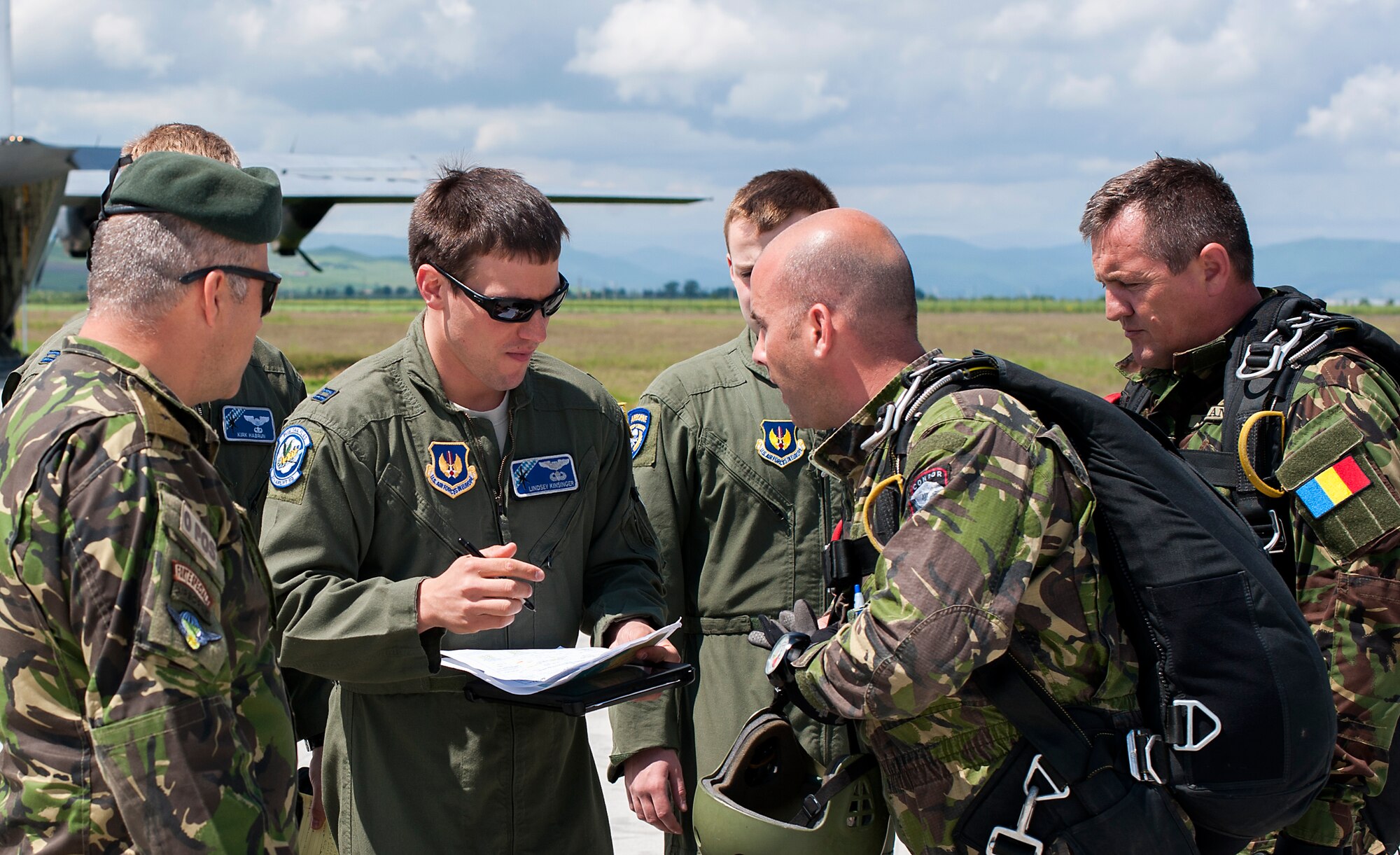 Members of the 37th Airlift Squadron and the Romanian Air Force coordinate jump procedures May 18, 2014, at Campia Turzii, Romania. The-two-week long training allowed C-130J aircrew to fly in less restrictive airspace, letting them utilize night vision capabilities and fly in low level formations. (U.S. Air Force photo/Senior Airman Damon Kasberg)