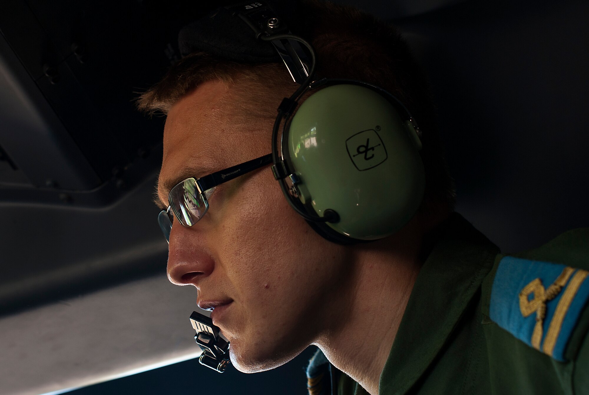 Romanian Air Force 1st Lt. Gheorghe Matis, C-27J pilot in training, watches pilots from the 37th Airlift Squadron perform preflight checks during Carpathian Spring 2014, May 18, 2014, in Bucharest, Romania. Gheorghe and many other Romanian pilots had the opportunity to observe from the flight deck as U.S. pilots conducted low-level, night and paratrooper operations. (U.S. Air Force photo/Senior Airman Damon Kasberg)