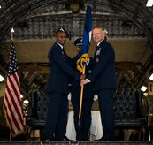 Brig. Gen. Darren Hartford is presented with his brigadier general guidon from Gen. Darren McDew, Air Mobility Command commander, during Hartford’s promotion ceremony May 22, 2014, at the HSC Hangar on Joint Base Charleston, S.C. Hartford's next assignment is commander, 379th Air Expeditionary Wing in Al Udeid. (U.S. Air Force photo/ Airman 1st Class Clayton Cupit)