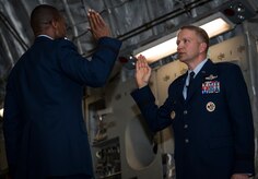 Brig. Gen. Darren Hartford takes an oath from Gen. Darren McDew, Air Mobility Command commander during Hartford’s promotion ceremony May 22, 2014, at the HSC Hangar on Joint Base Charleston, S.C. Hartford's next assignment is commander, 379th Air Expeditionary Wing in Al Udeid. (U.S. Air Force photo/ Airman 1st Class Clayton Cupit)